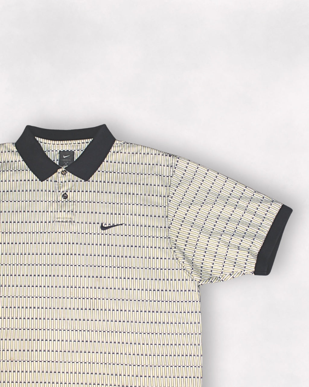 Patterned polo shirt with Nike logo on a light gray background