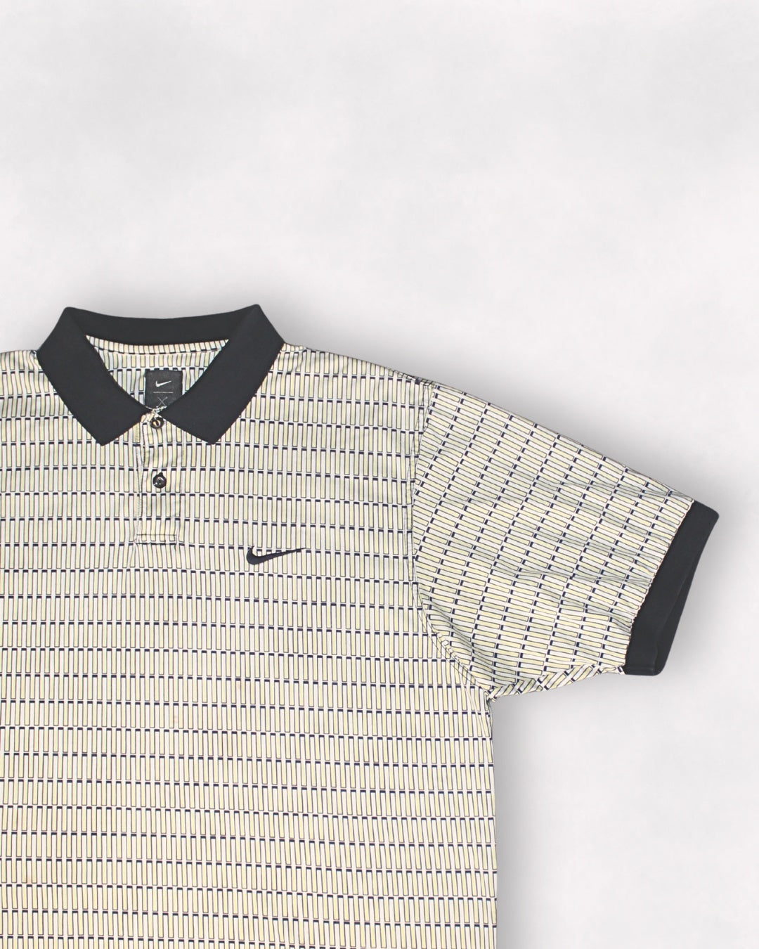 Patterned polo shirt with Nike logo on a light gray background